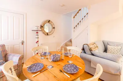 a dining room with a wooden table and chairs at The Lobster Pot in Aldeburgh