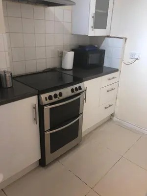 a kitchen with a stove and a counter top at Waltham Abbey Private Property in Waltham Abbey