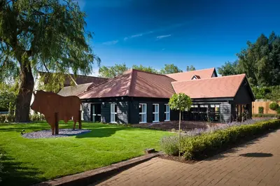 a house with a cow statue in front of it at The Bull at Great Totham Limited in Great Totham