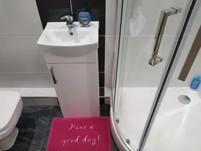 a bathroom with a shower and a sign that says have a good day at Observation Court in Ipswich