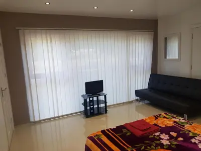 a living room with a couch and a tv at Observation Court in Ipswich