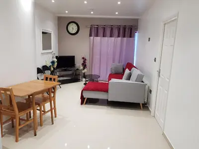 a living room with a couch and a table at Observation Court in Ipswich