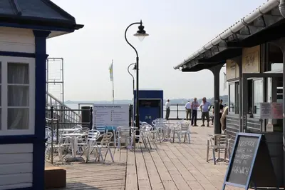 a group of tables and chairs on a boardwalk at On the Quay in Harwich