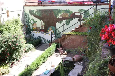a garden with a tree painted on the side of a building at On the Quay in Harwich
