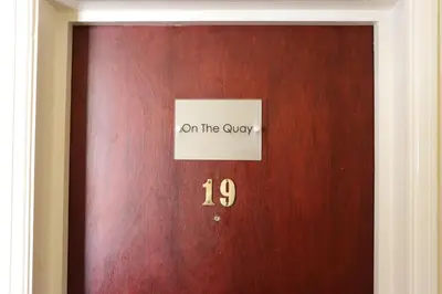 a wooden door with a sign on the only at On the Quay in Harwich