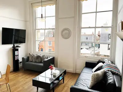 a living room with a couch and a table at On the Quay in Harwich