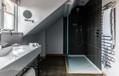 a bathroom with a shower with a glass door at Crown and Castle in Orford