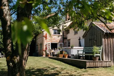 a house with a bench in front of it at Retreat East in Ipswich