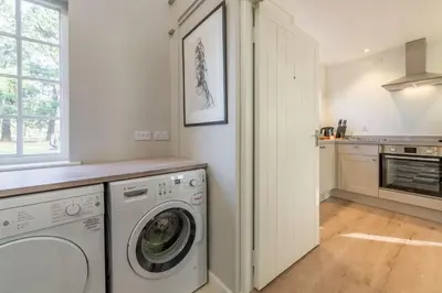 a laundry room with a washer and dryer at Marsh View in Aldeburgh