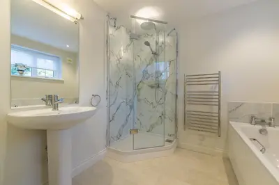 a bathroom with a shower and a sink and a shower at Marsh View in Aldeburgh