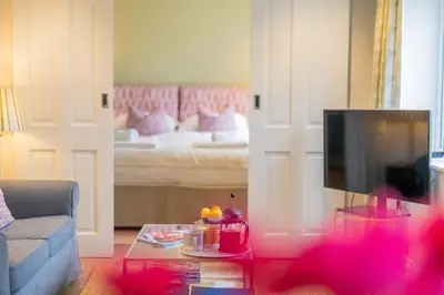 a living room with a couch and a bed at Marsh View in Aldeburgh