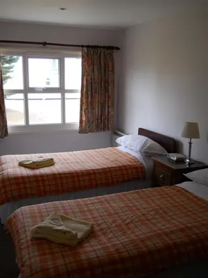 a hotel room with two beds and a window at Richmond Park Golf Club in Watton