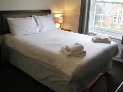 a hotel room with a bed with towels on it at Rose and Crown Hotel in Haverhill