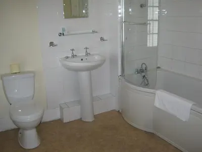 a bathroom with a sink and a toilet and a shower at Rose and Crown Hotel in Haverhill