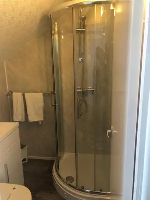 a shower with a glass door in a bathroom at The Grosvenor in Clacton-on-Sea