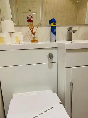 a white bathroom with a sink and a mirror at The Grosvenor in Clacton-on-Sea