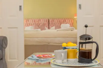 a coffee maker on a table in a living room at Marsh Lodge in Aldeburgh