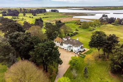 an aerial view of a large white house with trees at Marsh Lodge in Aldeburgh