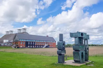 a sculpture in a field in front of a building at River View in Aldeburgh