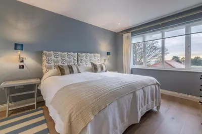 a bedroom with a large bed and a window at River View in Aldeburgh