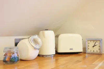 a group of appliances sitting on top of a wooden floor at Hertford Barn conversion in Hertford