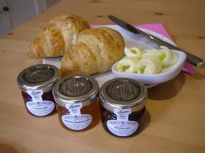 a table with three jars of bread and croissants at Grove Barn Bed and Breakfast in Harleston