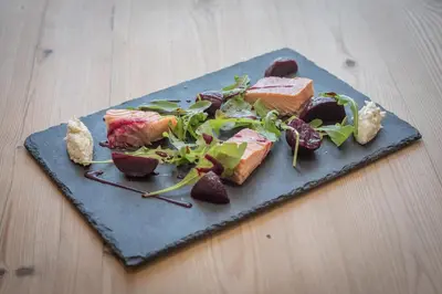 a plate of food with meat and salad on a table at The Golden Key in Snape