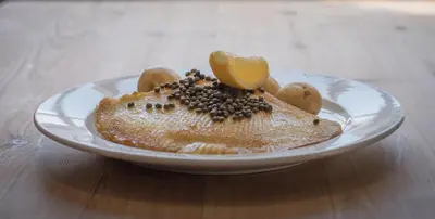 a plate with a dessert on a wooden table at The Golden Key in Snape
