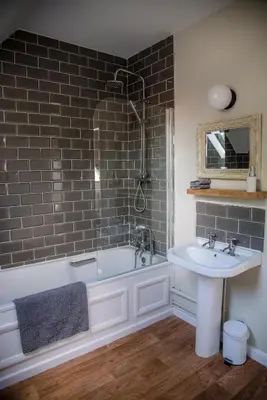 a bathroom with a bath tub and a sink at The Golden Key in Snape