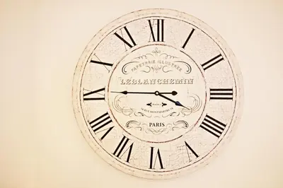 a clock with roman numerals on a wall at Star Apartment Ipswich, A Hidden Gem near the Waterfront in Ipswich