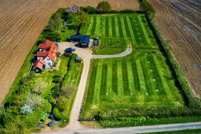 a house in the middle of a field at Brick Kiln Apartment in Campsea Ashe