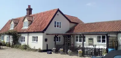 a white house with a red roof at Brick Kiln Apartment in Campsea Ashe
