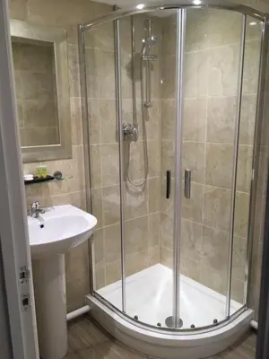 a bathroom with a shower and a sink at The Annexe at Asbit Lodge in Mildenhall
