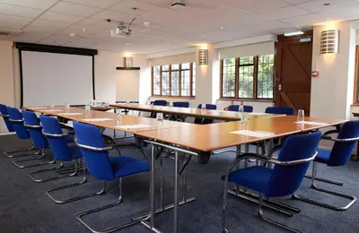 a conference room with a long table and chairs at Bull Hotel by Greene King Inns in Long Melford