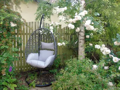 a swing in a garden next to a fence at Horseshoe House - Ukc2743 in Watton