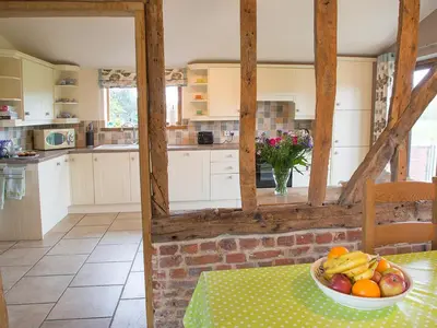 a kitchen with a bowl of fruit on a table at Henry's Barn - Ukc3168 in Walpole