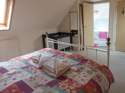 a bedroom with a bed with a quilt on it at Old Dairy - Ukc3169 in Walpole
