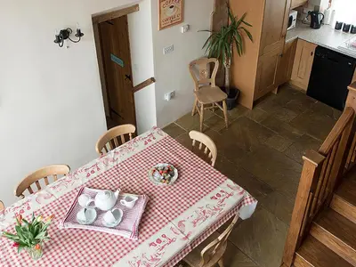 a table in a kitchen with a red and white table cloth at Old Corn Mill - Ukc3170 in Walpole