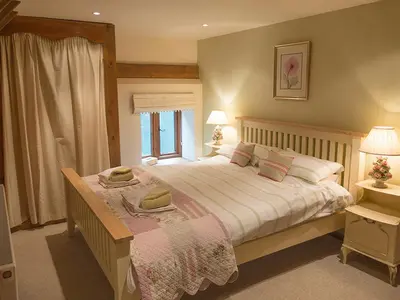 a bedroom with a large bed and a window at Old Corn Mill - Ukc3170 in Walpole