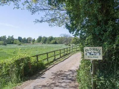 a sign on a dirt road next to a fence at Old Corn Mill - Ukc3170 in Walpole