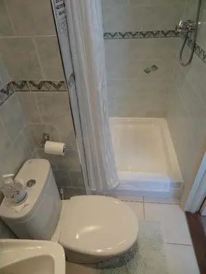 a bathroom with a toilet and a bath tub at The Chudleigh in Clacton-on-Sea