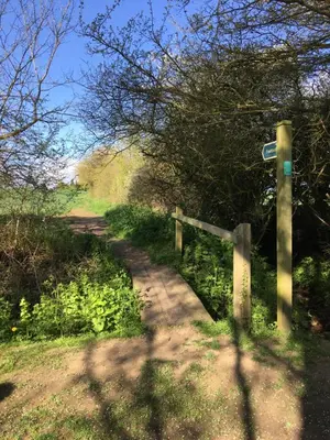 a dirt road with a fence on the side at Square House Bildeston High street in Ipswich