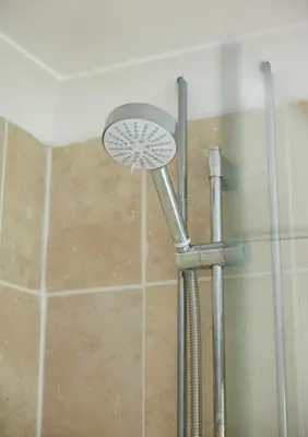 a shower with a shower head in a bathroom at Old Ferry Boat by Greene King Inns in St Ives