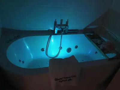a blue bath tub with a faucet in a bathroom at Stay 69G - Hush View House, Romford, London Havering in Romford