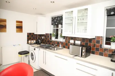 a kitchen with a sink and a washing machine at Stay 69G - Hush View House, Romford, London Havering in Romford