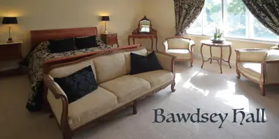 a bedroom with a bed and a couch at Bawdsey Hall in Bawdsey