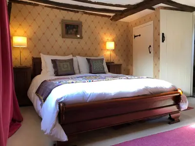 a bedroom with a large bed in a room at Crown House Great Glemham in Saxmundham