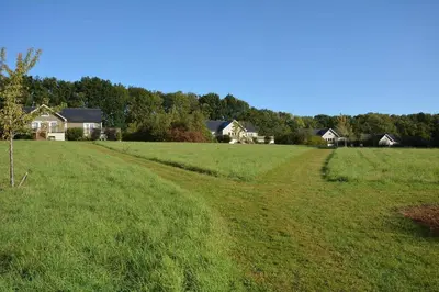 a field of green grass with houses in the background at Endymion Lodge in Colchester