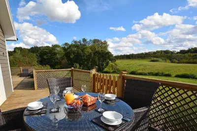 a table with a bowl of food on a patio at Endymion Lodge in Colchester