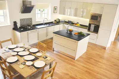 a kitchen with a dining room table with plates on it at Ransom Lodge in Chappel